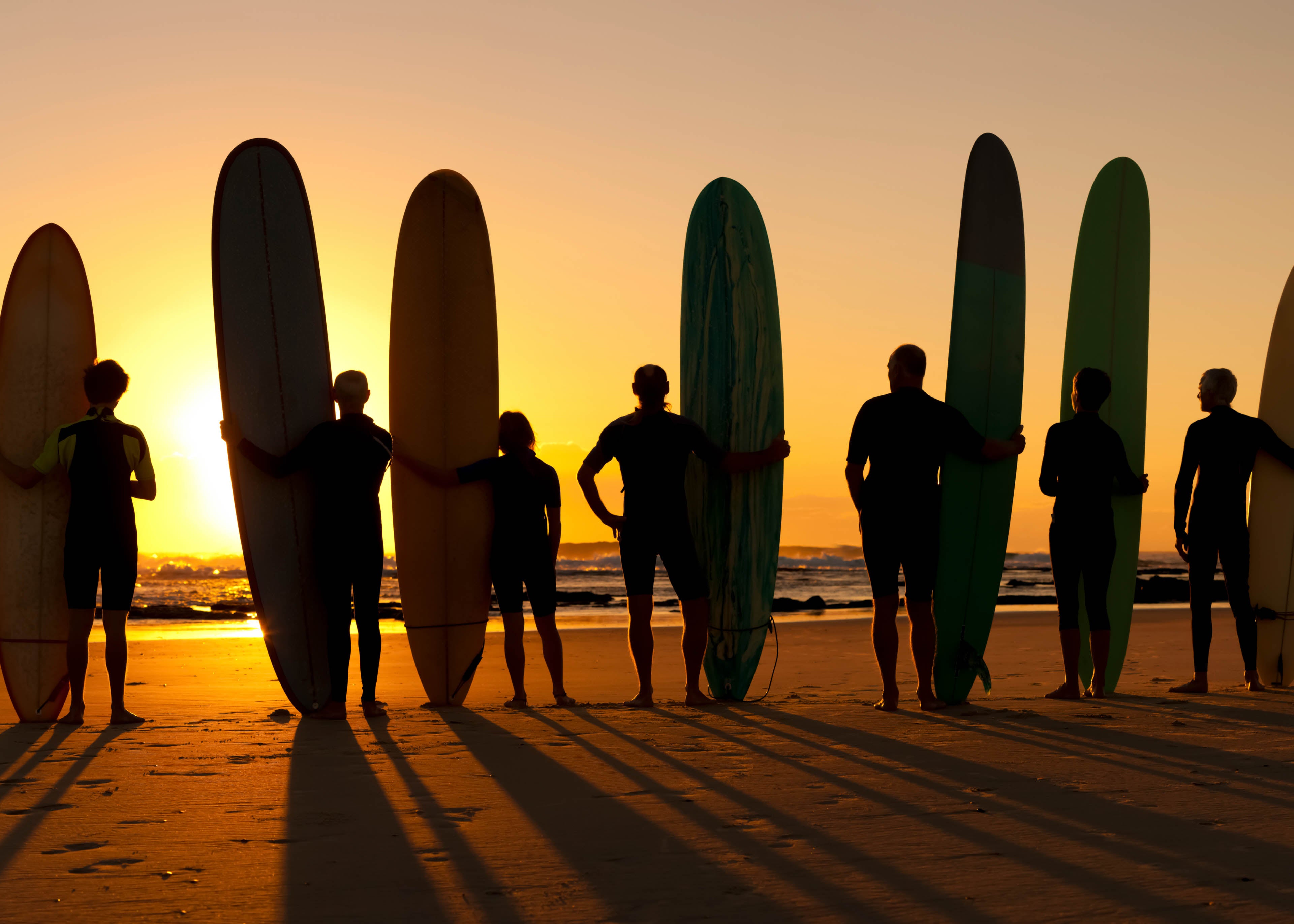 Surfers on beach at sunset iStock 171252100 crop 840x600 02f95c07 94af 4a6c 9fa7 2a2cb7130ea5